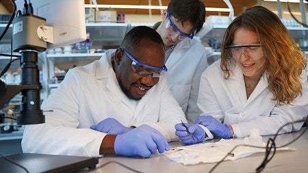 Felix Deku and researchers working in lab